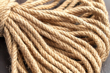 Bundle of fibrous sustainable knotted jute rope close up. knotted jute rope