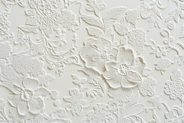 A light white textured surface with intricate, raised patterns that mimic the appearance of delicate lace, creating a tactile, three-dimensional effect.