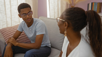 Obraz premium Mother and son talking warmly in their living room home interior highlighting family love and connection