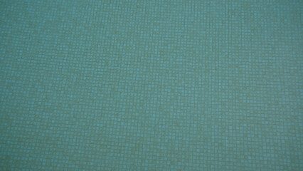 Turquoise mosaic tiles create a vibrant underwater texture, ideal for swimming pool backgrounds or bathroom designs in a seamless square pattern.