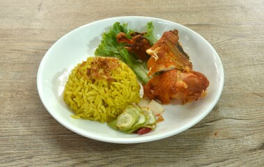 chop fried chicken and biryani rice cooked with curry on plate dipping sweet chili sauce  