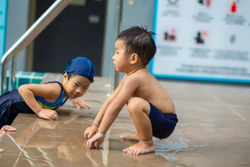 Fotobehang Ontspanning Sister and brother kids enjoying swim in condominium pool outdoor exercise  © themorningglory