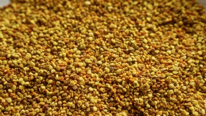 Closeup view of scattered bee pollen granules showcasing food, bee, pollen in an organic, natural...