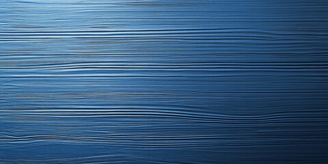 A blue textured surface with a soft, brushed finish, showcasing fine, parallel lines that add a soft, linear texture.