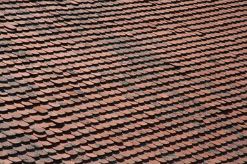 
Old roof made of red clay tiles. Pattern. Texture. Red tile gable roof. Background with copy space.