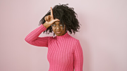 African american woman in pink posing indoors with glasses