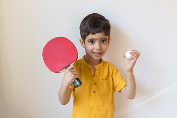 Boy plays ping pong isolated on white background. Child with table tennis racket. Sports concept