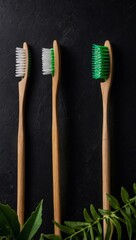 Wooden toothbrushes paired with green leaves on a black surface, illustrating a zero-waste concept, with room for text or design.