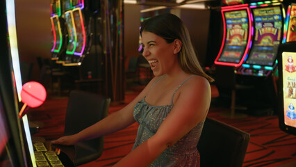 A joyful woman playing a slot machine in a vibrant casino exudes excitement and entertainment.