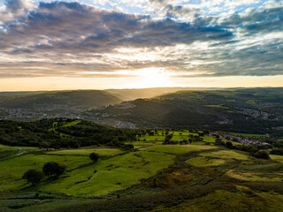 Sunset casting shadows over the green hills of wales