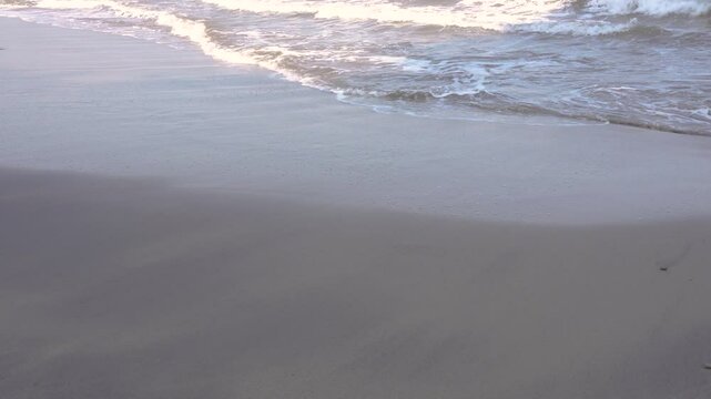 close up footage of waves crashing on the shore in the afternoon.