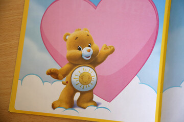 
Children's book with the character of Funshire bear. Yellow care bear with heart background with...