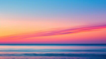 Obraz premium Serene Ocean Sunset, a blurred horizon where the sun dips below the water, enveloped in warm hues, creating a tranquil summer evening ambiance.