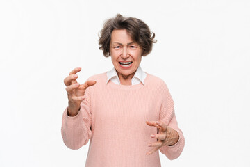 Angry mature woman on white background. Portrait of elderly senior lady grandmother feeling...