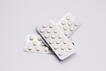 Blister Packs of White Pills on a White Background