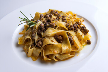 Plate with pappardelle with wild boar ragout sauce and rosemary