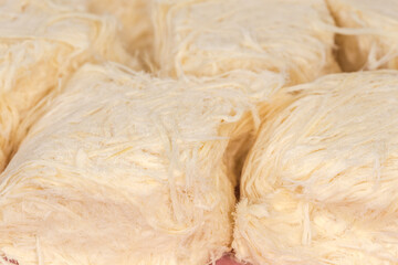 Traditional Turkish sweets pishmanie on pink dish, close-up