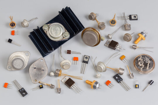 Old transistors various purpose in different packages on gray surface