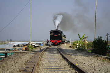 Historic steam engine with heavy dark grey smoke