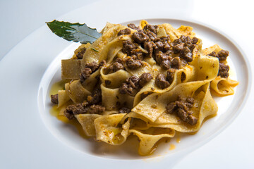 Plate with pappardelle with wild boar ragout sauce with bay leaf