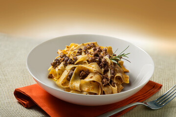 White bowl with pappardelle with wild boar ragout sauce
