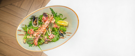 seafood salad di mare. Calamari, shrimp, clams. Long banner format. top view. copy space