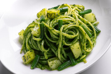 Bowl with linguine with Genoese pesto sauce with potatoes and green beans