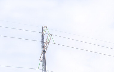 high voltage mast for transmission of electricity close-up with wires on the background of the sky