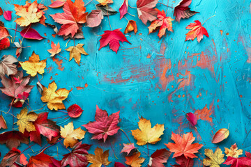 Autumnal background with colorful leaves on blue background. Copy space, top view