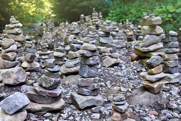 Stack of zen stones, natural pebble rocks stacked on top of each other in stream in a forest. Concept of harmony and balance
