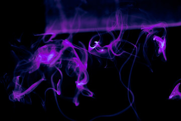 Illustration of purple beautiful smoke on the black background 