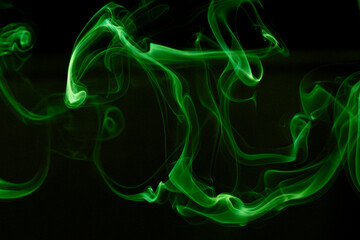 Illustration of green beautiful smoke on the black background 