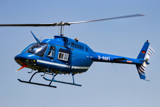 Bell 206 JetRanger helicopter with passengers about to land at Ahlen-Nord heliport. Germany
