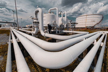 Male worker inspection at steel long pipes and pipe elbow in station oil factory during refinery valve of visual check record