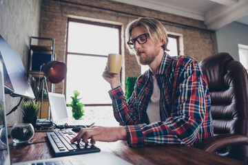 Photo of young it specialist man blond hair wearing eyeglasses and checkered shirt sitting...