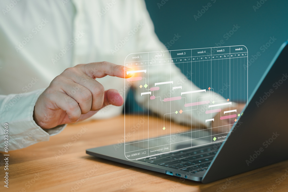 Poster Person hand interacts with a digital Gantt chart displayed on a laptop screen, representing modern project management, task scheduling, and workflow optimization in a business environment.