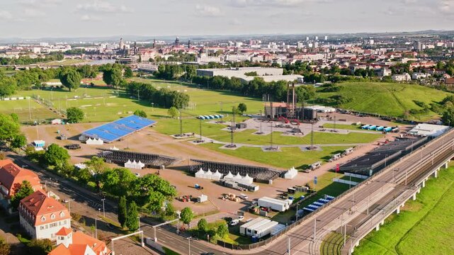 Drone video of a massive stage being set up for a RAMMSTEIN concert. construction process and the scale of the stage, highlighting the vibrant event preparations. Drone move forward.