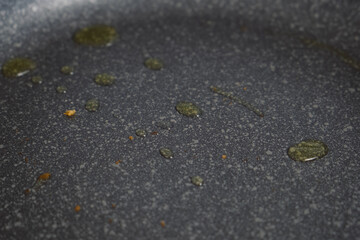 Vegetable oil on skillet to cook or fry food, close-up view. Preparing frying on pan to cooking dish on gas oven. Cuisine, culinary, recipe.