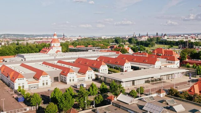 Drone video of the Dresden Messe showcasing its modern architecture and expansive layout. The footage provides a comprehensive view of the venue and its surroundings. Drone move left.