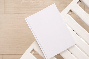 blank book cover mockup on wooden outdoor table, hotel balcony or terrace