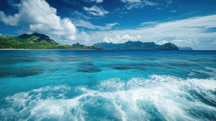The clear blue waters of the Mamanuca Islands with small waves breaking on the shore.