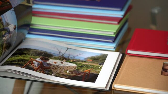 Father looks at family memory album photos with the birth of newborn son , memories of childhood and growth of the child year after year. Dad and son lifestyle , parent remembers the child's childhood