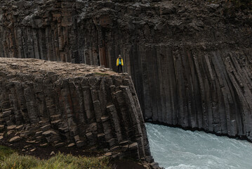 Lone traveler on the edge of a rocky cliff