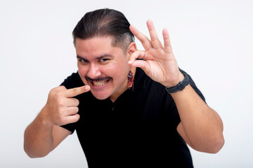 A mischievous middle aged man deviously grinning while holding a fake cockroach for a prank. Set...