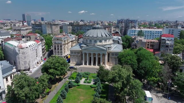Romanian Atheneum in Bucharest. Aerial 4k video of this amazing landmark historical building from Bucharest, Romania, on Victoriei Avenue (Calea Victoriei). Travel to Romania.