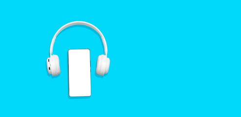 White wireless headphones and mobile phone isolated on blue background, copy space