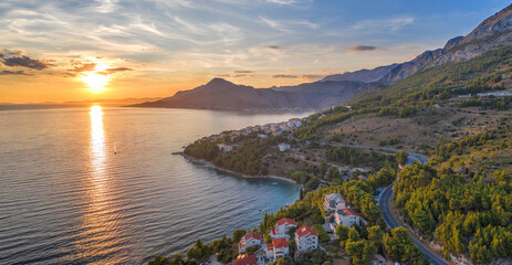Stanici village with main beach against sunset over the sea near the Omis in Croatia