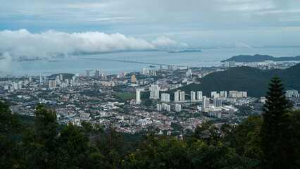Obraz premium An aerial view of Penang island, travel destinations, downtown district, cityscape or landscaped from Penang hill, Malaysia, panoramic skyscraper. tower and apartment.