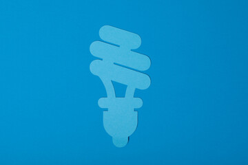 Paper lightbulb on a blue background Energy efficiency is key