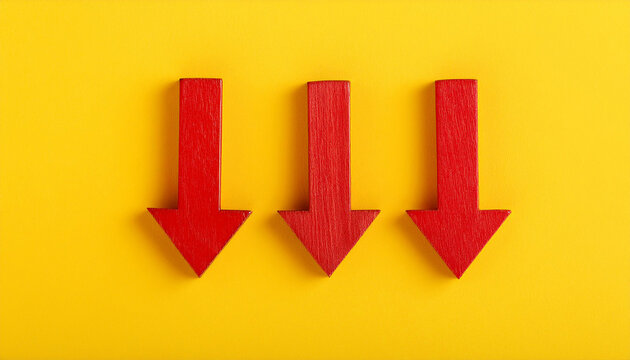Red wooden arrow pointing down on yellow background. Business, market decline or economic